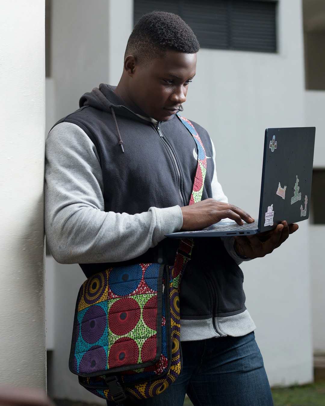 A man working on a laptop while standing